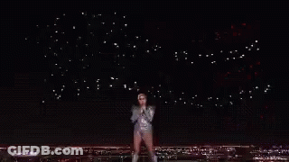 A Crowd Of People Watching A Wrestling Match In A Stadium GIF