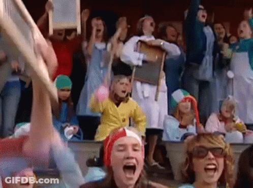 A Crowd Of People Wearing Costumes Are Screaming And Cheering GIF