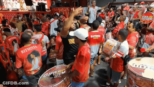 A Crowd Of People Wearing Red And White Shirts With The Word Ritmo On Them GIF