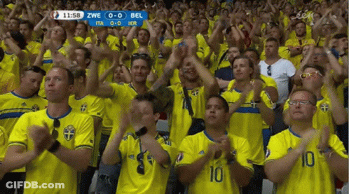 A Crowd Of People Wearing Yellow Shirts With The Number 10 On The Front GIF