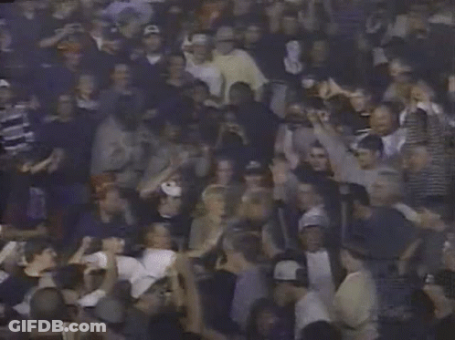 A Crowd Of People With Their Hands In The Air Including A Man Holding A Sign That Says ' A ' GIF