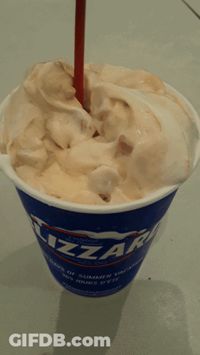 A Cup Of Blizzard Ice Cream With A Straw In It GIF