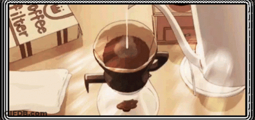 A Cup Of Coffee Is Being Poured Into A Glass Cup On A Table . GIF