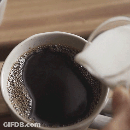 A Cup Of Coffee Is Being Poured Into Another Cup GIF