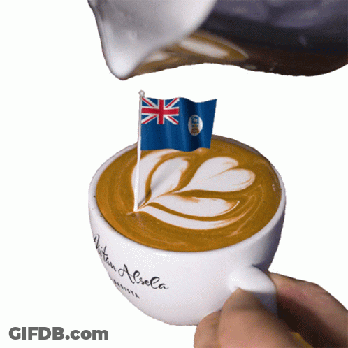 A Cup Of Coffee Is Being Poured With A British Flag On Top GIF