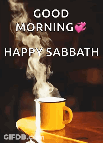 A Cup Of Coffee Is Sitting On A Wooden Table With Smoke Coming Out Of It And The Words `` Good Morning Happy Sabbath '' GIF