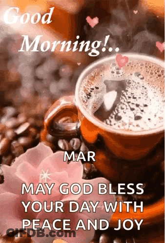 A Cup Of Coffee Is Sitting On Top Of A Table Next To A Flower . GIF