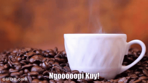 A Cup Of Coffee Sits On A Pile Of Coffee Beans With The Words Ngooooopi Kuy Above It GIF