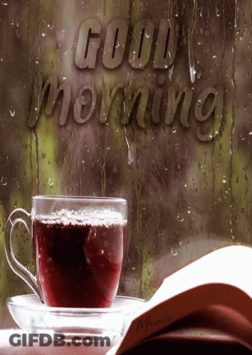 A Cup Of Coffee Sits On A Saucer Next To A Book That Says Good Morning On It GIF