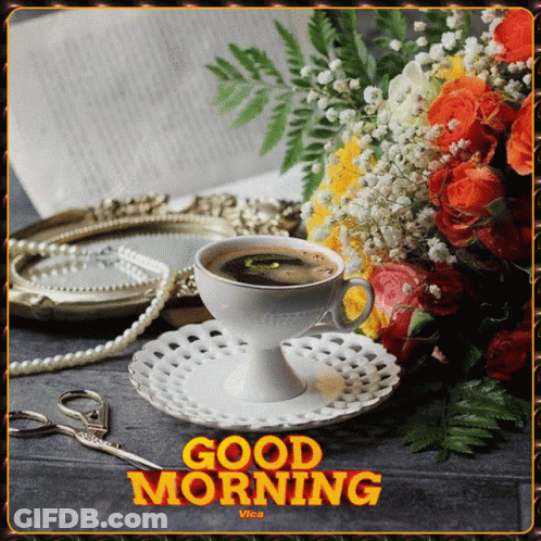 A Cup Of Coffee Sits On A Saucer Next To A Bouquet Of Flowers And Pearls GIF