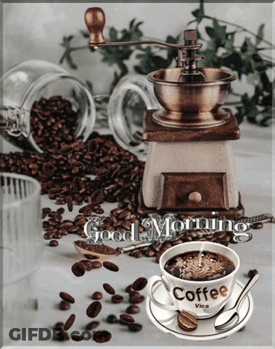 A Cup Of Coffee Sits On A Saucer Next To A Coffee Grinder With The Words Good Morning Written On It GIF