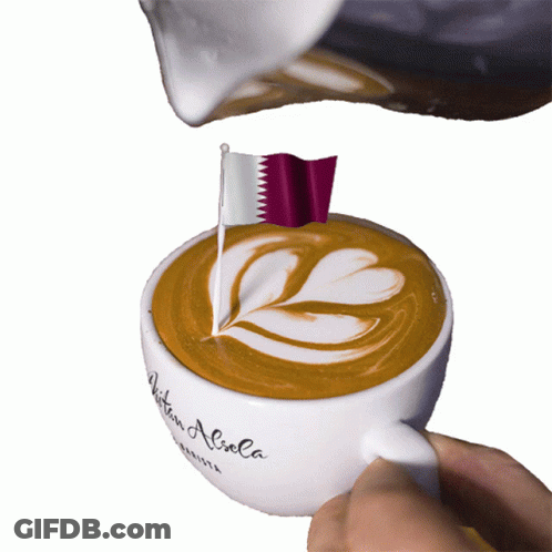A Cup Of Coffee With A Flag On Top Of It GIF