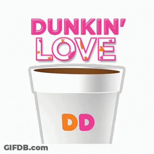 A Cup Of Coffee With A Heart Shaped Doughnut In It GIF