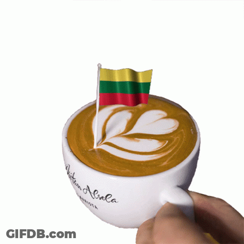 A Cup Of Coffee With A Small Flag On Top Of It GIF