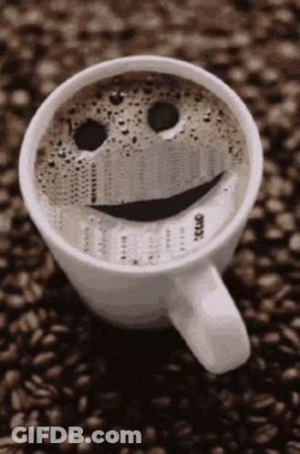 A Cup Of Coffee With A Smiley Face On The Top GIF