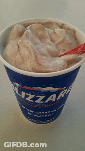 A Cup Of Dairy Queen Blizzard Ice Cream With A Red Spoon GIF