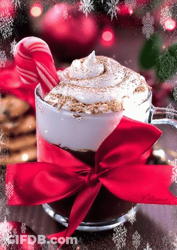 A Cup Of Hot Chocolate With A Red Bow And Candy Cane GIF