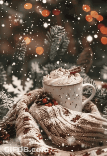 A Cup Of Hot Cocoa With Whipped Cream And Cinnamon Sticks GIF