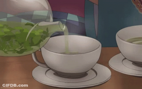 A Cup Of Tea Is Being Poured From A Pitcher GIF