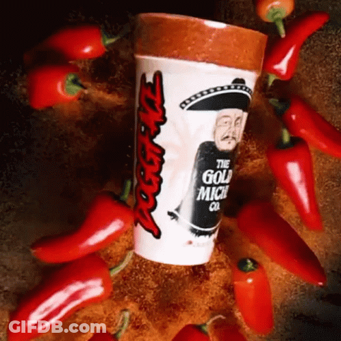 A Cup That Says ' The Gold Mich Co ' On It Surrounded By Red Peppers GIF