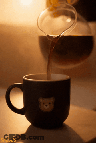 A Cup With A Teddy Bear On It Is Being Poured GIF