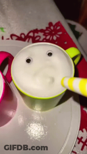 A Cup With Googly Eyes And A Yellow And White Striped Pen GIF