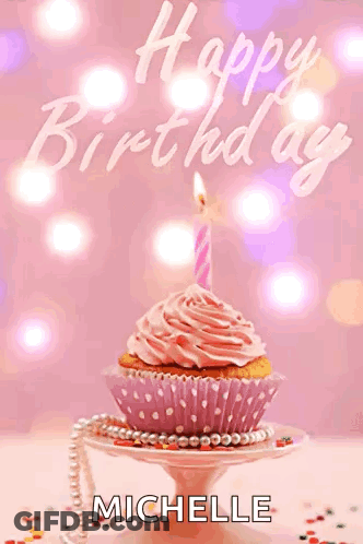A Cupcake With A Pink Frosting And A Lit Candle Is On A Plate With The Name Michelle On It GIF