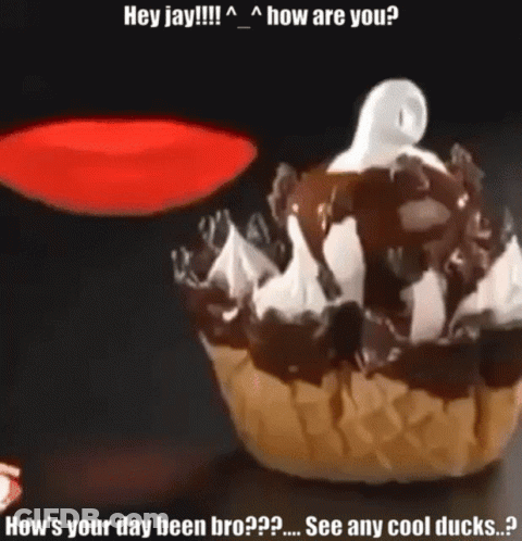 A Cupcake With Chocolate Sauce And Whipped Cream Has A Ghost On Top Of It GIF