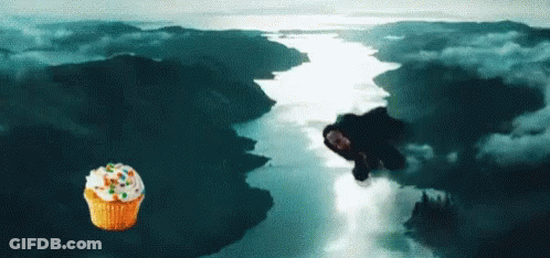 A Cupcake With Frosting And Sprinkles Is Flying Over A River GIF