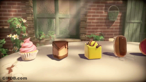 A Cupcake With Pink Frosting Sits On A Table Next To A Slice Of Cake GIF