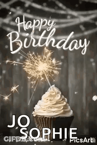 A Cupcake With Whipped Cream And Sparklers On Top Of It . GIF