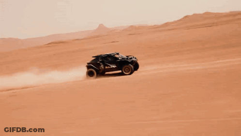 A Dacia Vehicle Is Driving Through A Desert GIF