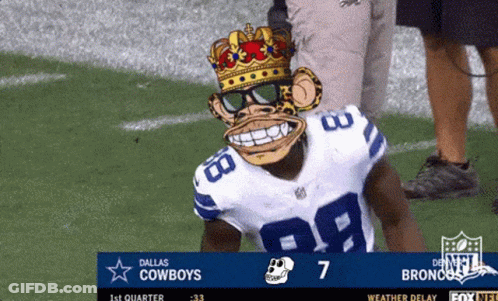 A Dallas Cowboys Football Player Wearing A Monkey Mask Stands On The Field GIF
