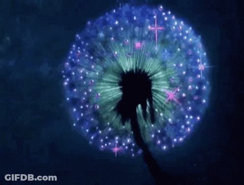A Dandelion With Purple And Green Petals Is Glowing In The Dark . GIF