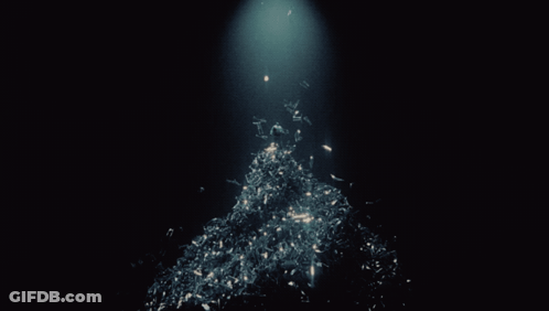 A Dark Background With A Light Shining On A Pile Of Papers GIF