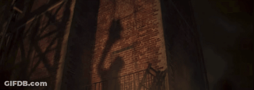 A Dark Brick Wall With A Fire Escape In Front Of It GIF