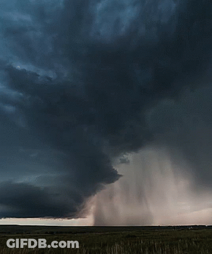 A Dark Cloudy Sky With A Few White Clouds GIF