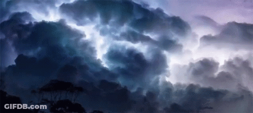 A Dark Cloudy Sky With A Lightning Bolt Coming Out Of It GIF