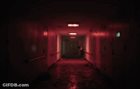 A Dark Hallway With Red Lights And A Door That Says 1 On It GIF
