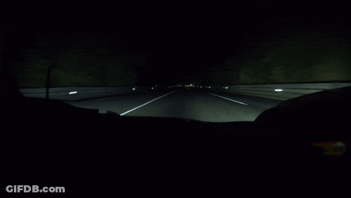 A Dark Highway With A White Line On The Right GIF