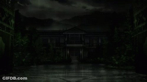 A Dark House With Green Leaves On The Ground And Mountains In The Background GIF