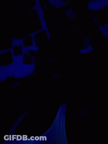 A Dark Room With A Blue Light Shining On The Wall GIF