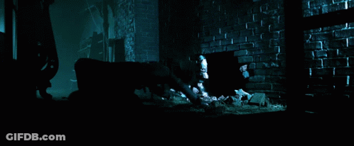 A Dark Room With A Brick Wall And A Hole In The Floor GIF