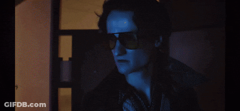 A Dark Room With A Door Open And A Window GIF