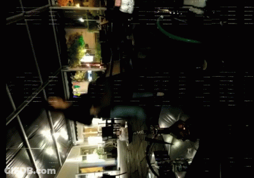 A Dark Room With A Few Lights On And A Few People GIF