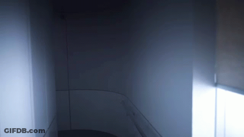 A Dark Room With A Light Coming Out Of The Window GIF
