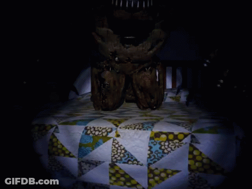 A Dark Room With A Quilt On The Floor GIF