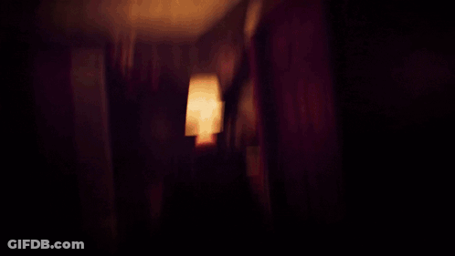 A Dark Room With A Red Light On The Ceiling GIF