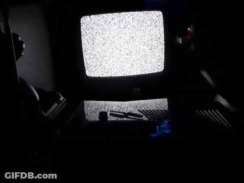 A Dark Room With A Tv That Has A Lot Of Static GIF