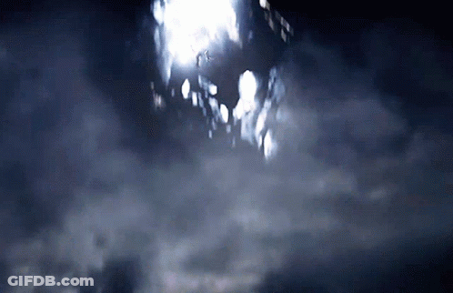A Dark Sky With A Few Clouds And A Building In The Distance GIF
